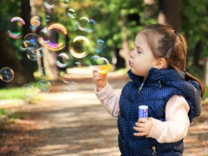 Synergetic Play Therapy: A child blowing bubbles.